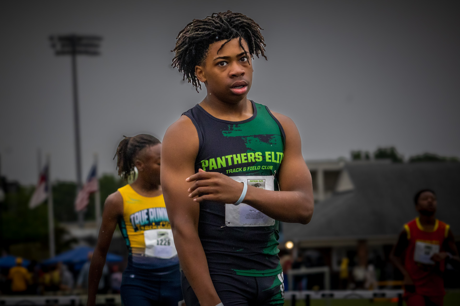 Female Panthers Elite track athlete preparing for a race at the outdoor meet.