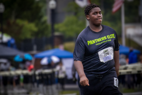 Young male athlete at Panthers Elite Track & Field Club during a race.