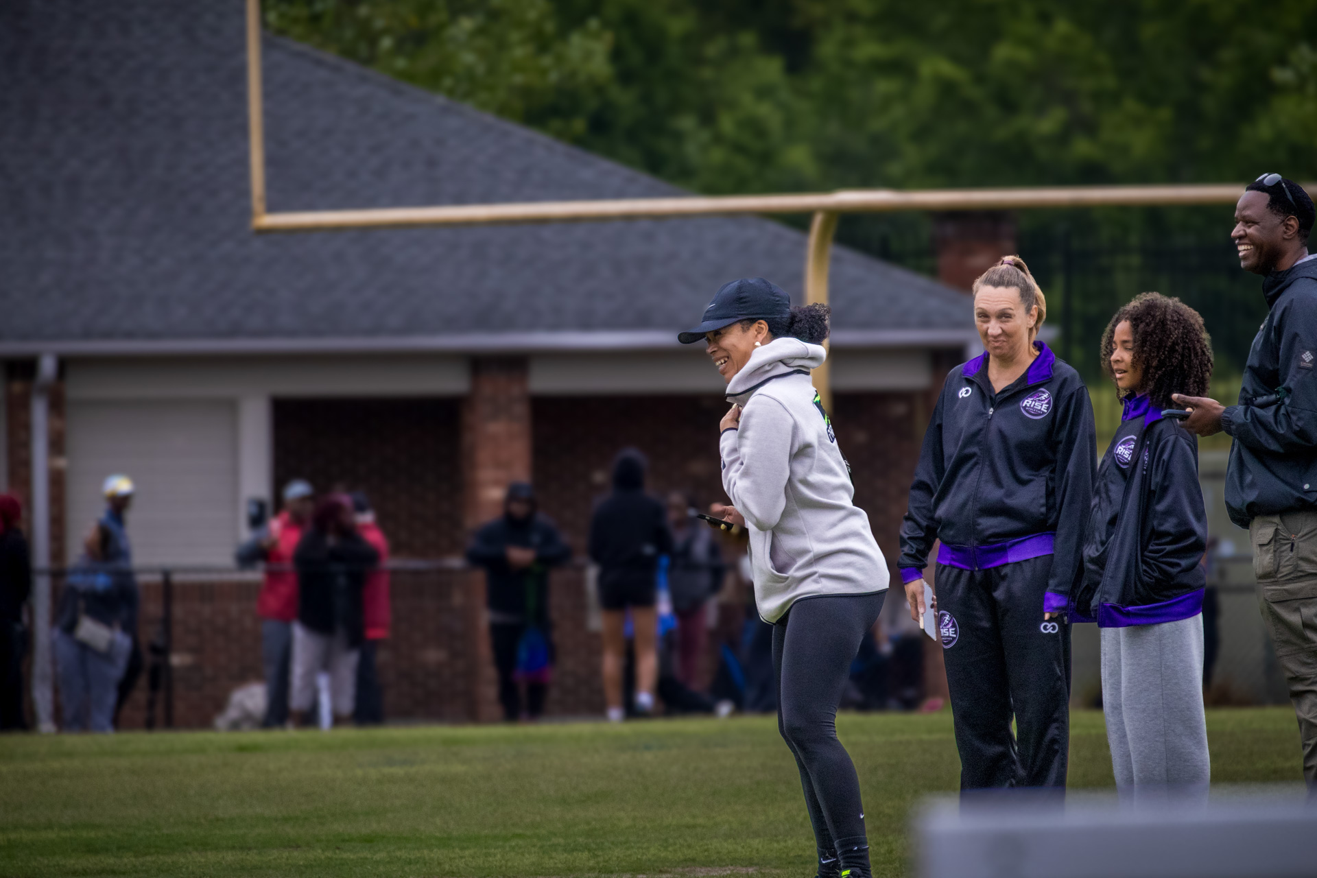 Panthers Elite athletes preparing for a track and field event on the field.