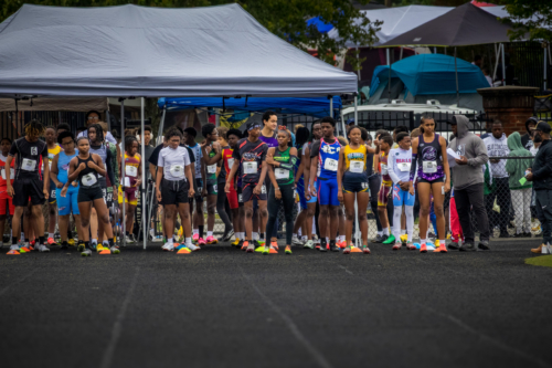 Young athletes at the Panthers Elite Track & Field Club starting line, ready for a race.