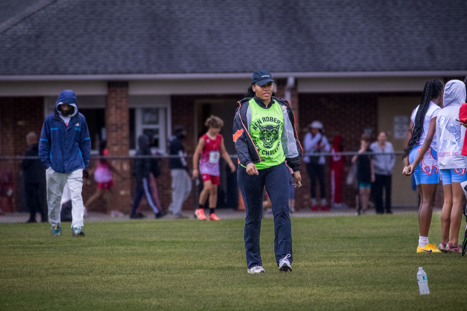 Panthers Elite coach overseeing young athletes during track practice.