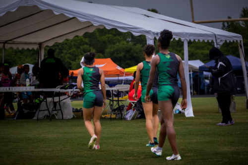 Panthers Elite track athletes walking on the field during a meet.