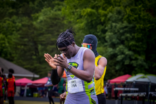 Panthers Elite track athletes preparing for a race at an outdoor meet.