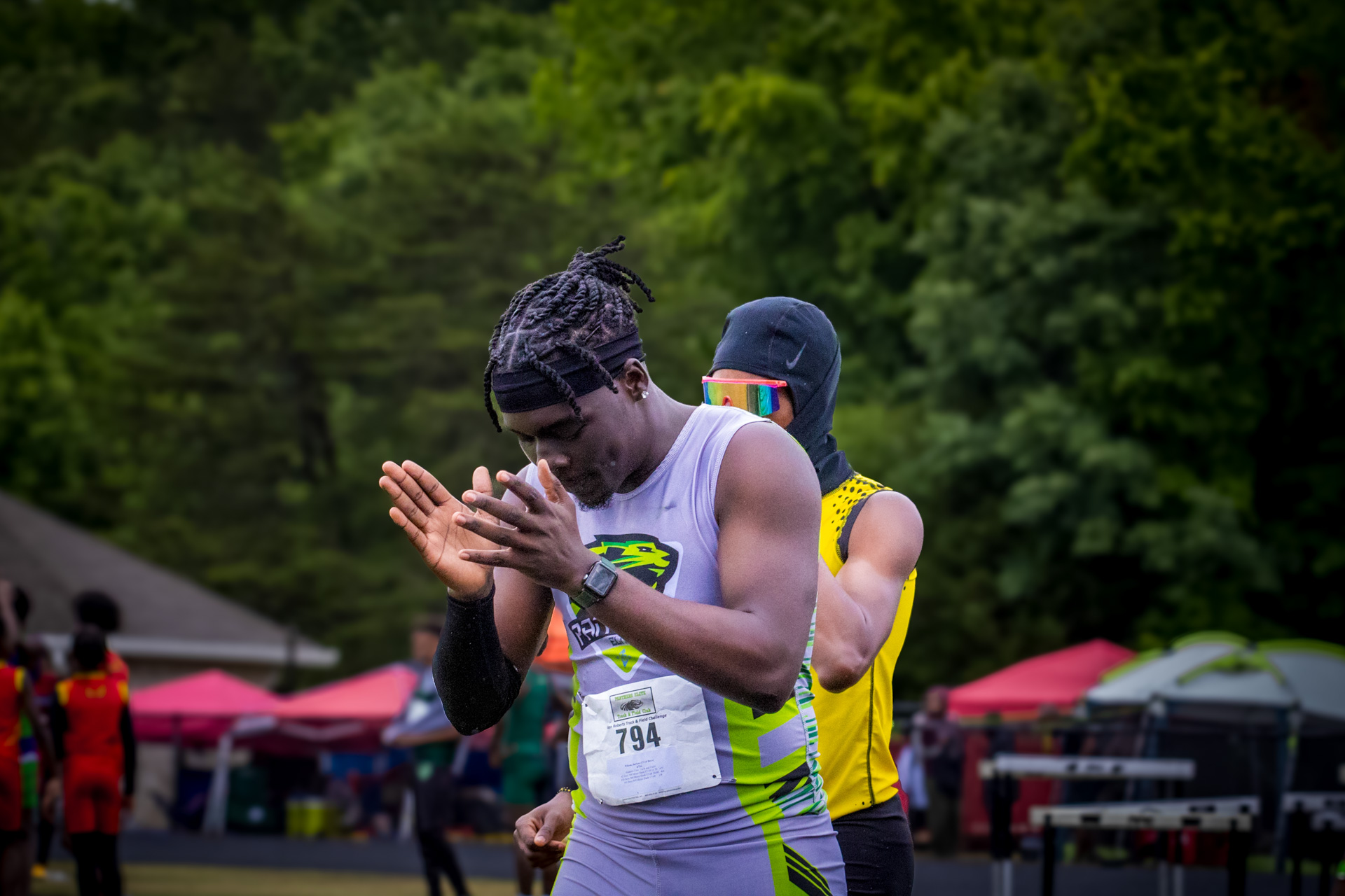 Panthers Elite track athletes preparing for a race at an outdoor meet.