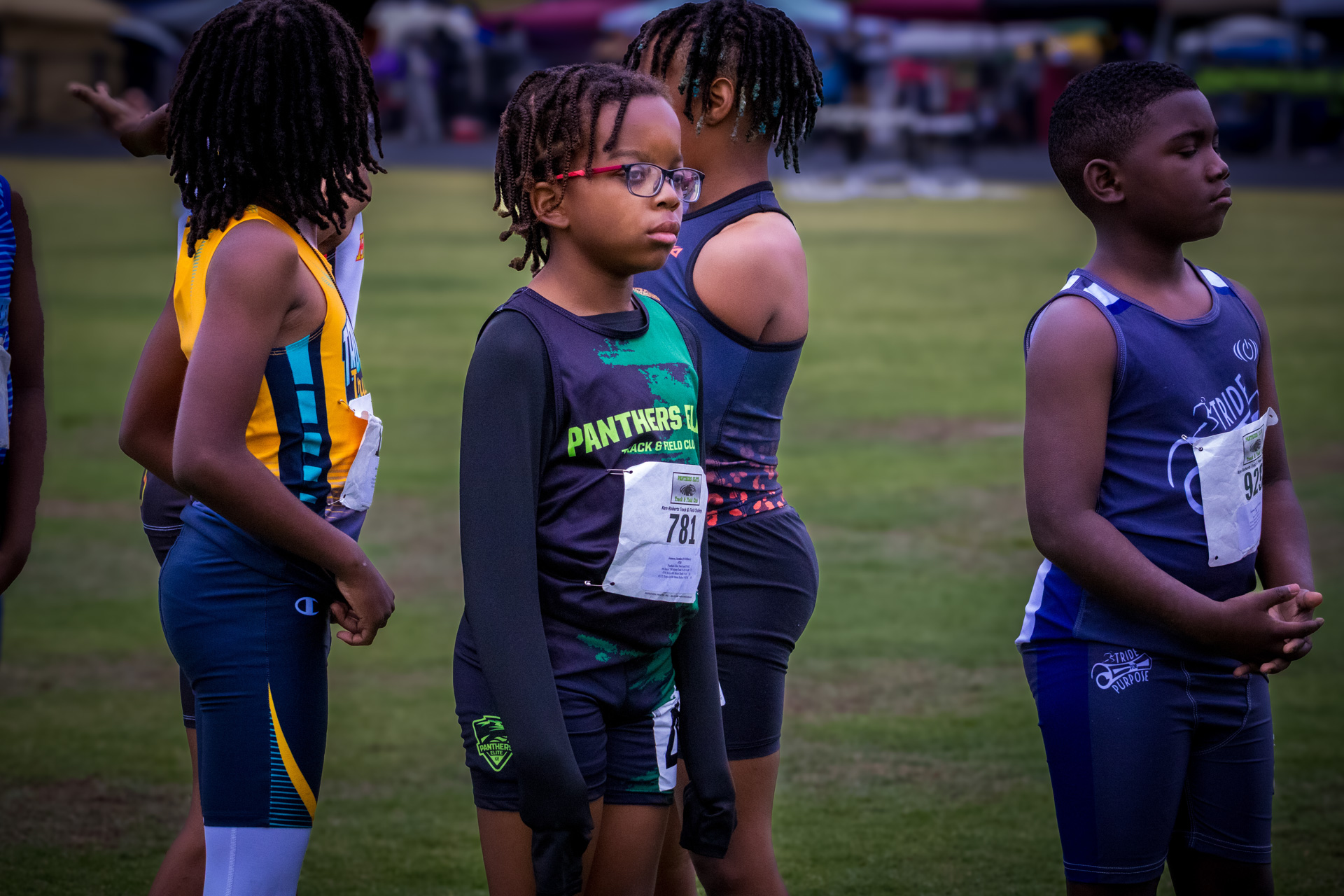 Young athletes from Panthers Elite Track & Field preparing for a race on the track.