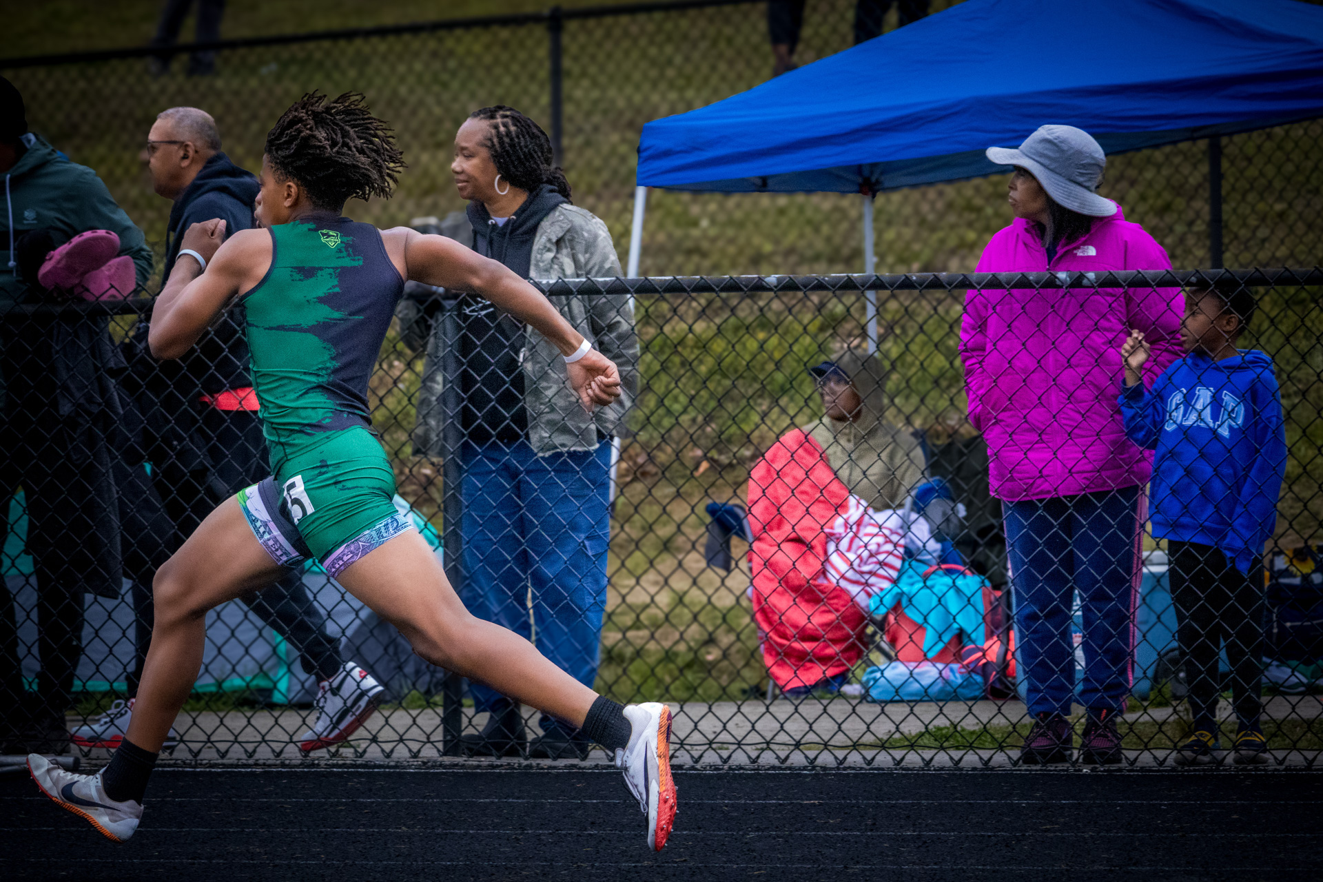 Female athlete sprinting during a track meet at Panthers Elite Track & Field Club.