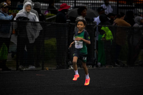Young girl running on track during a race at Panthers Elite Track & Field Club event.