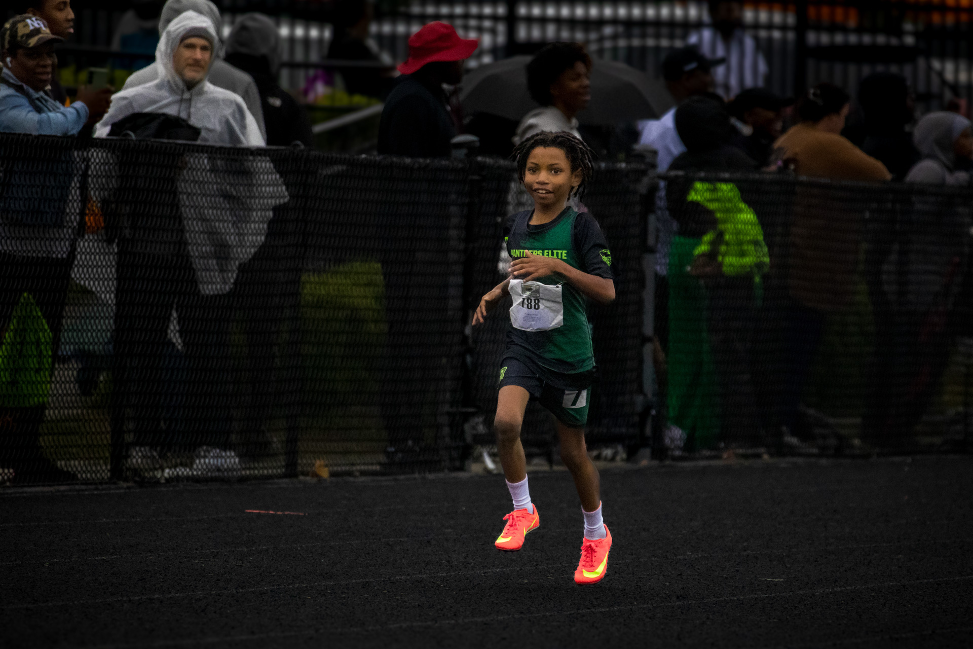Young girl running on track during a race at Panthers Elite Track & Field Club event.