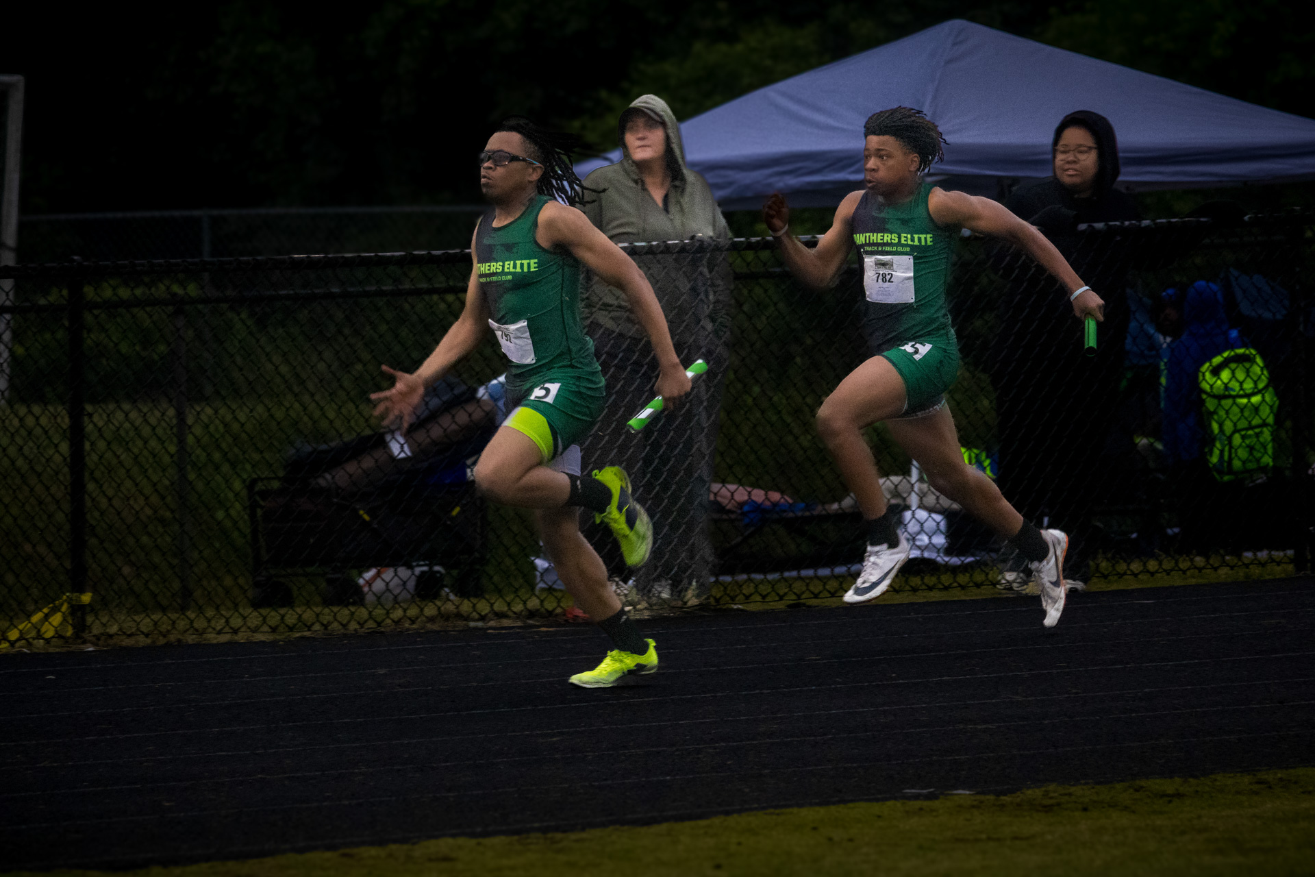 Two Panthers Elite athletes sprinting on the track during a race.