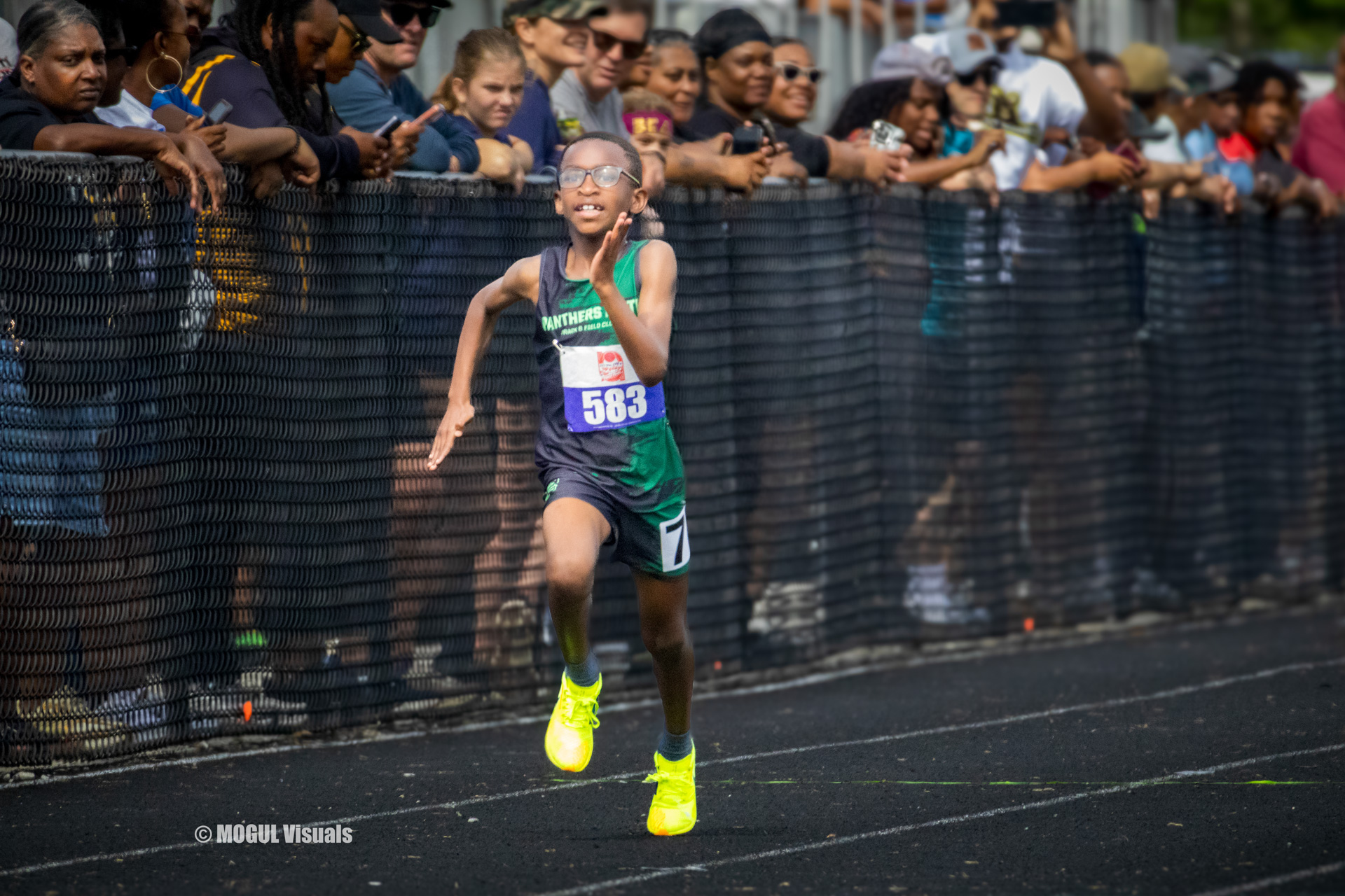 Young athlete sprinting on the track during a race.