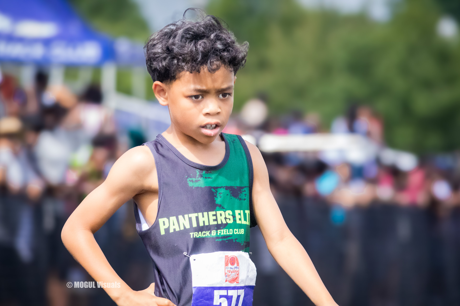 Young male athlete competing in a track event, focused and determined during a race.