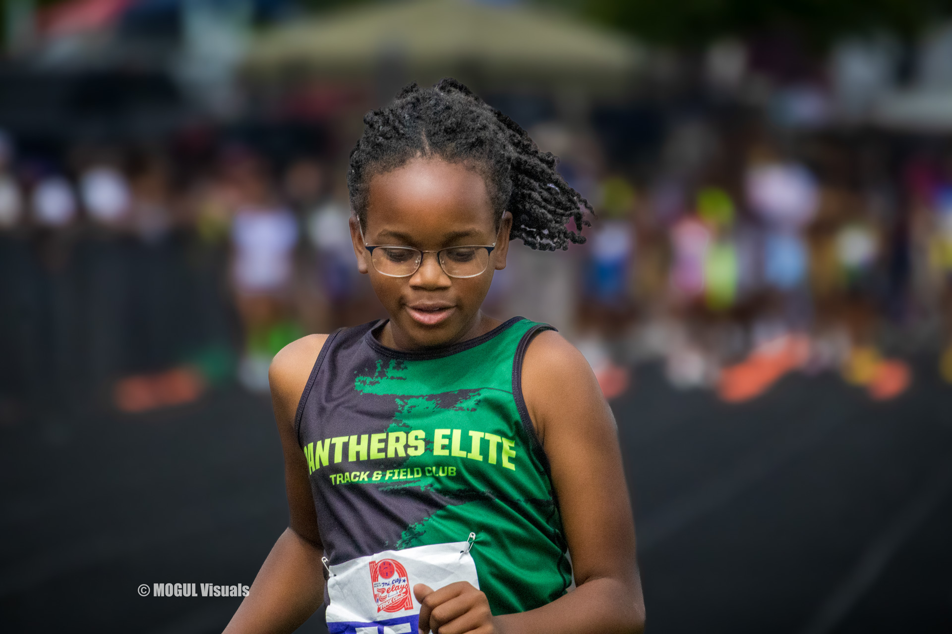 Young girl in Panthers Elite Track & Field uniform at a track meet.