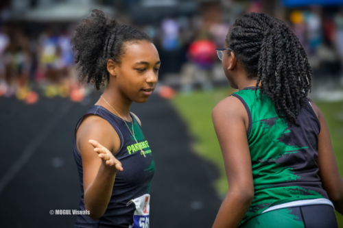 Two Panthers Elite Track & Field athletes talking during a meet.