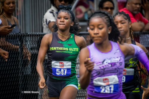 Young female athletes competing in a track race at Panthers Elite Track & Field Club event.