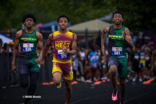 Three young male athletes competing in a track race at Panthers Elite Track & Field Club.