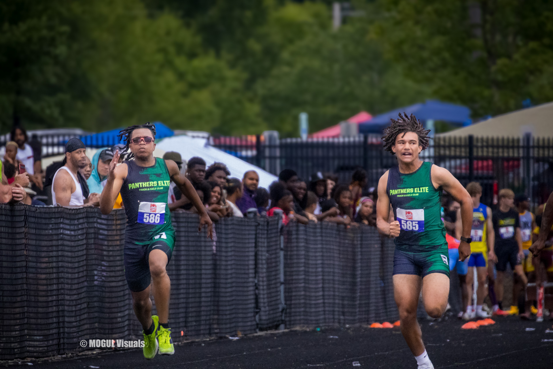 Panthers Elite Track & Field athletes competing in a race on an outdoor track.