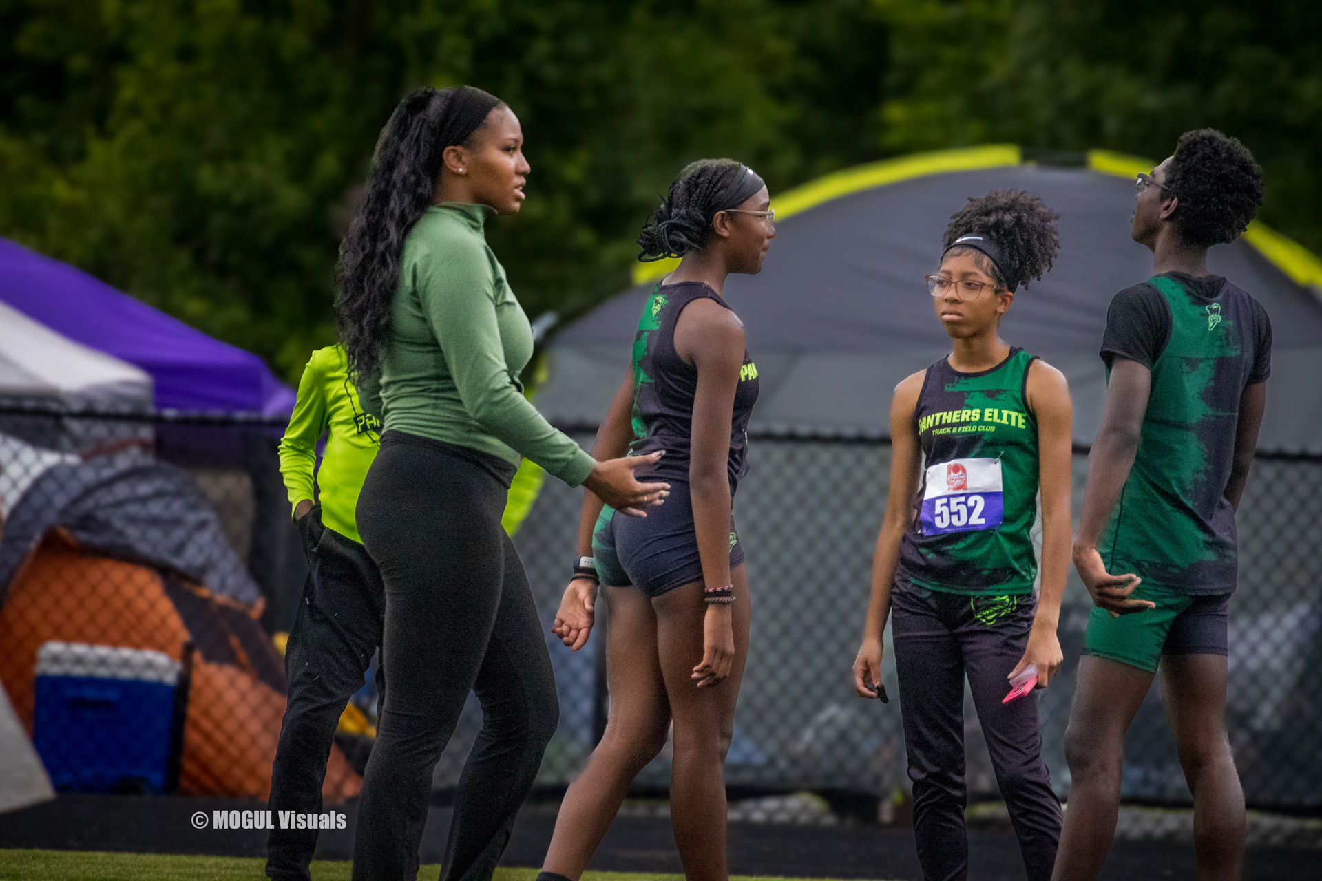 Panthers Elite track athletes preparing for a race at an outdoor meet.