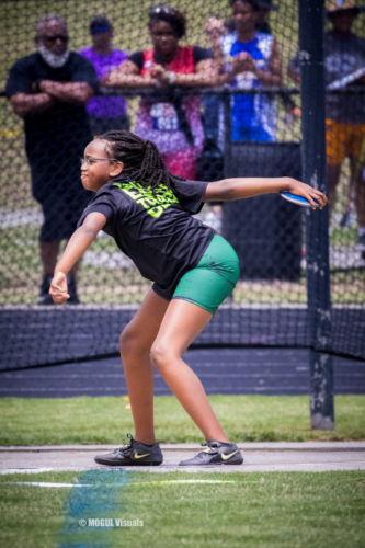 Athlete preparing to throw a discus during a track meet.