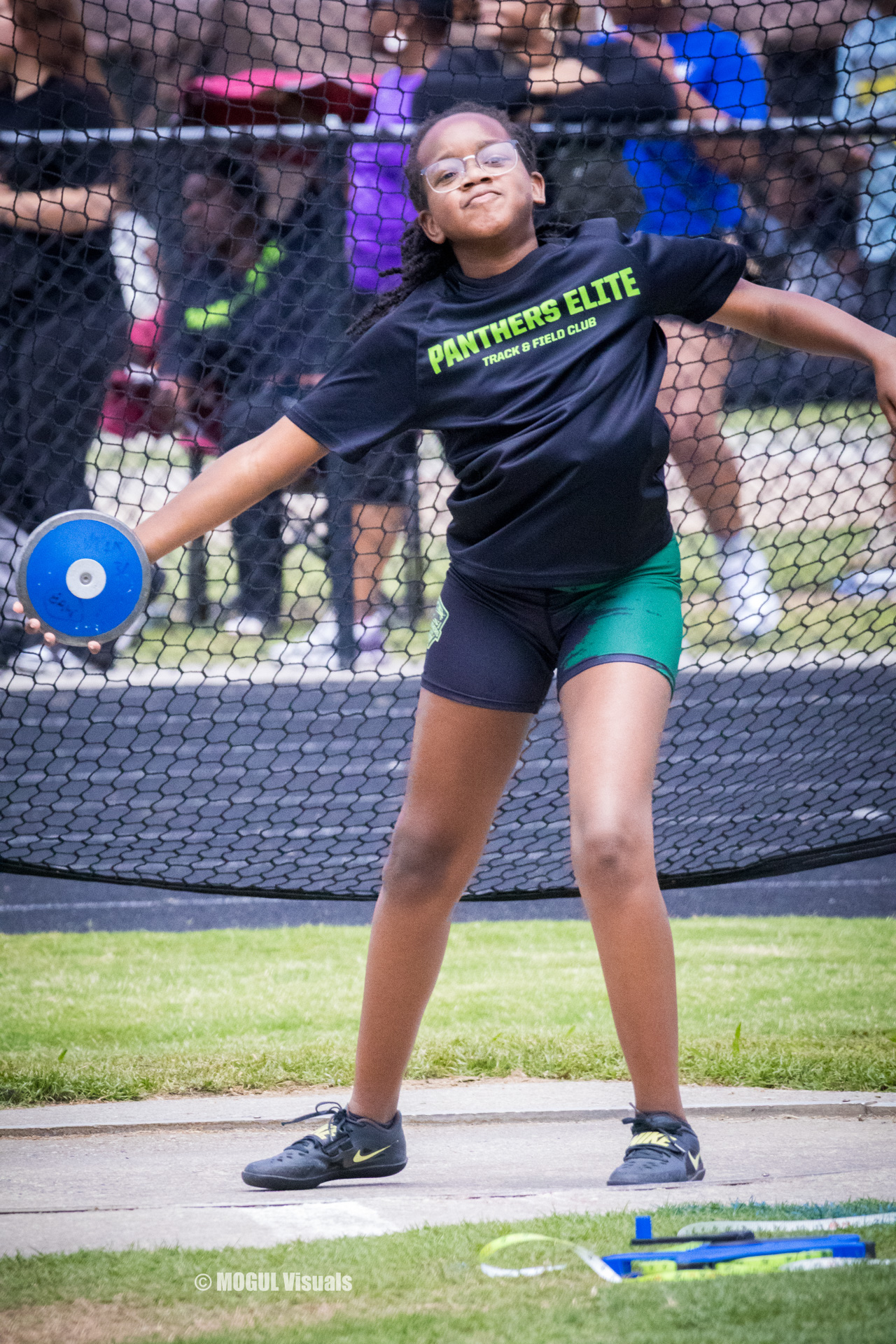 Young athlete from Panthers Elite Track & Field Club throwing discus during practice.
