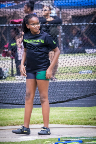 Young female athlete in Panthers Elite T-shirt at track and field event.