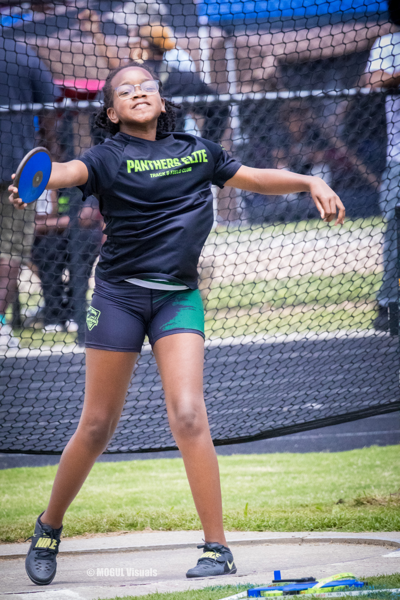 Young female athlete practicing discus throw at Panthers Elite Track & Field event.