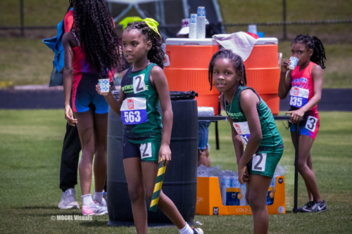 Young athletes from Panthers Elite Track & Field preparing for a race at a track meet.