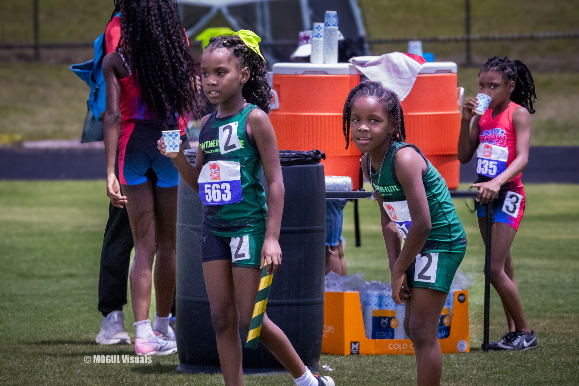 Young athletes from Panthers Elite Track & Field preparing for a race at a track meet.