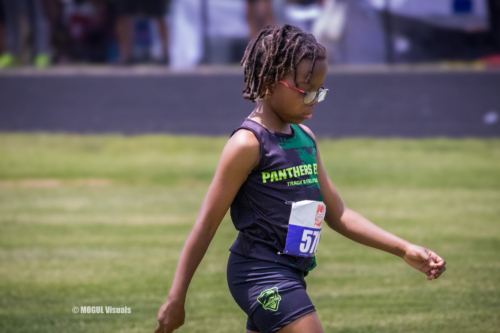 Young female athlete running on track during a Panthers Elite meet.