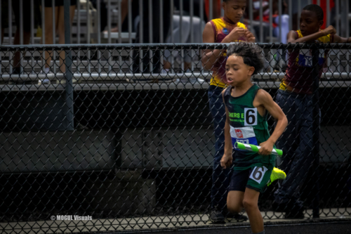 Young athlete running in a track event at Panthers Elite Track & Field Club.