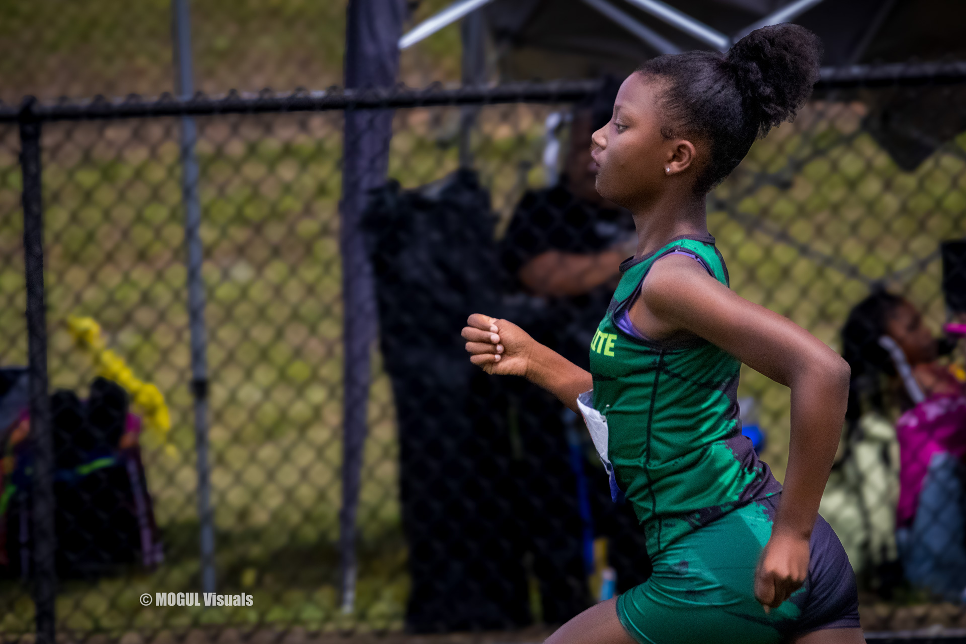 Young female athlete running on a track during a Panthers Elite Track & Field event.