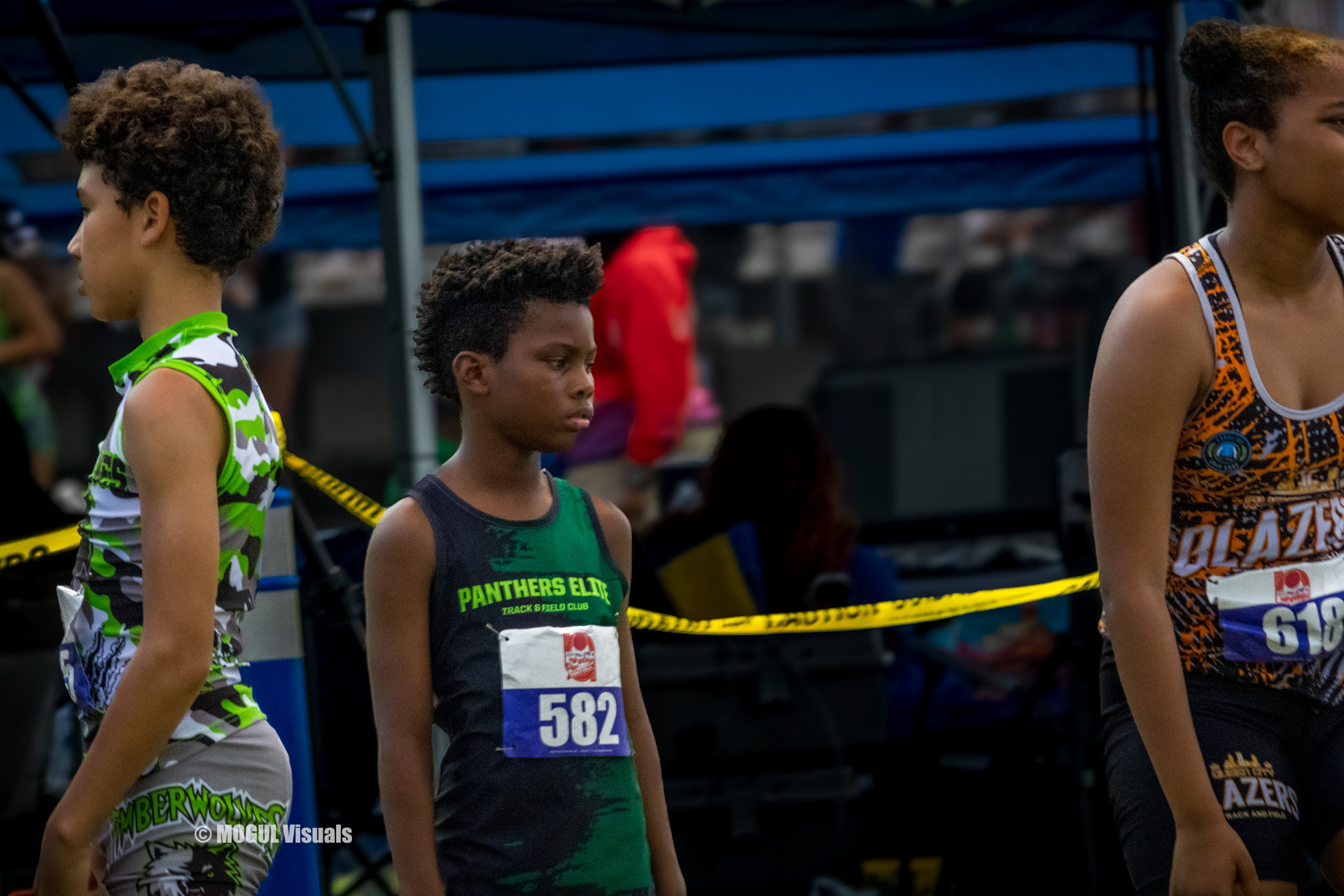 Young Panthers Elite athletes preparing for a track event at a meet.