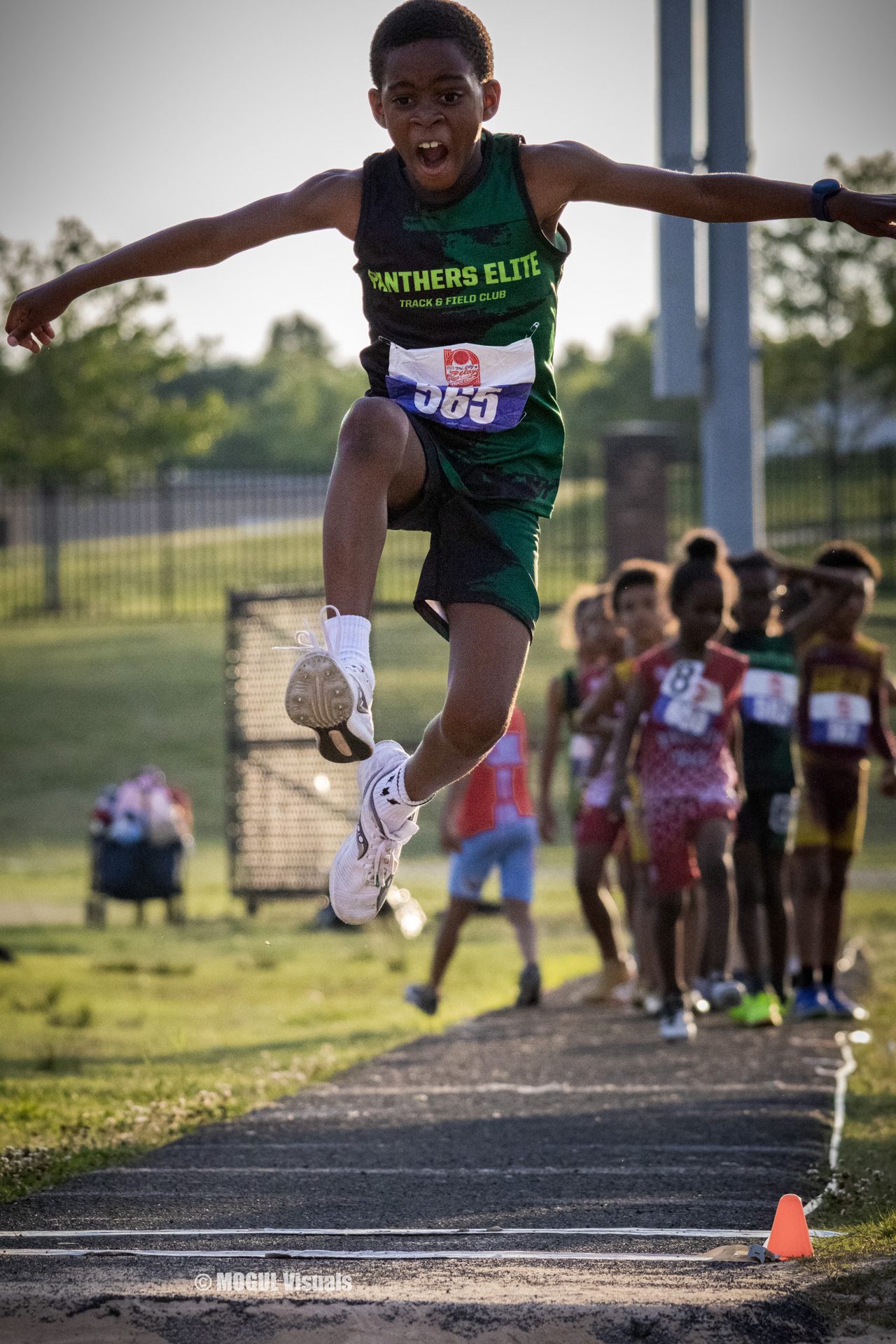 Young athlete from Panthers Elite Track & Field jumping during a race.
