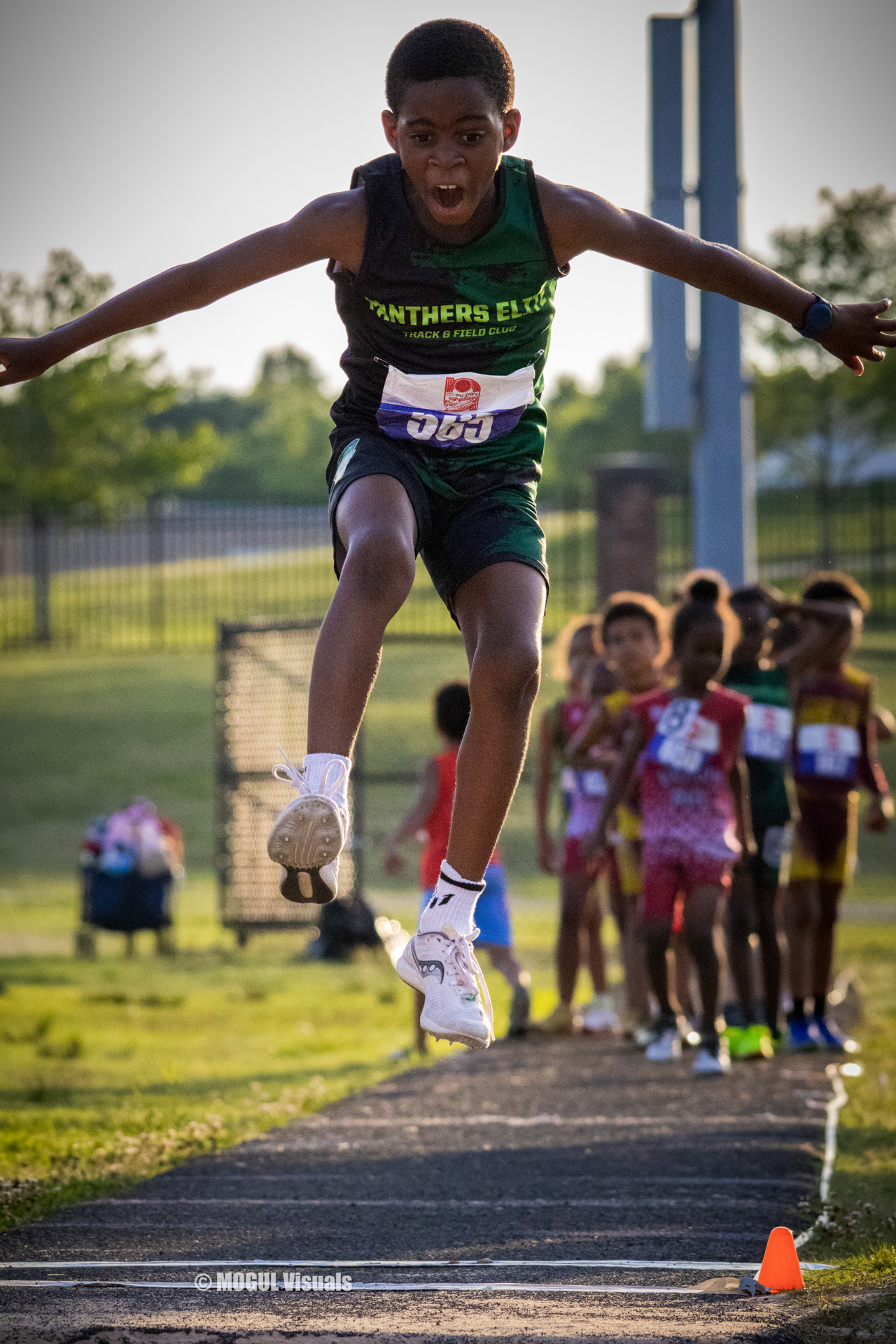 Young athlete jumping during a track and field event at Panthers Elite.