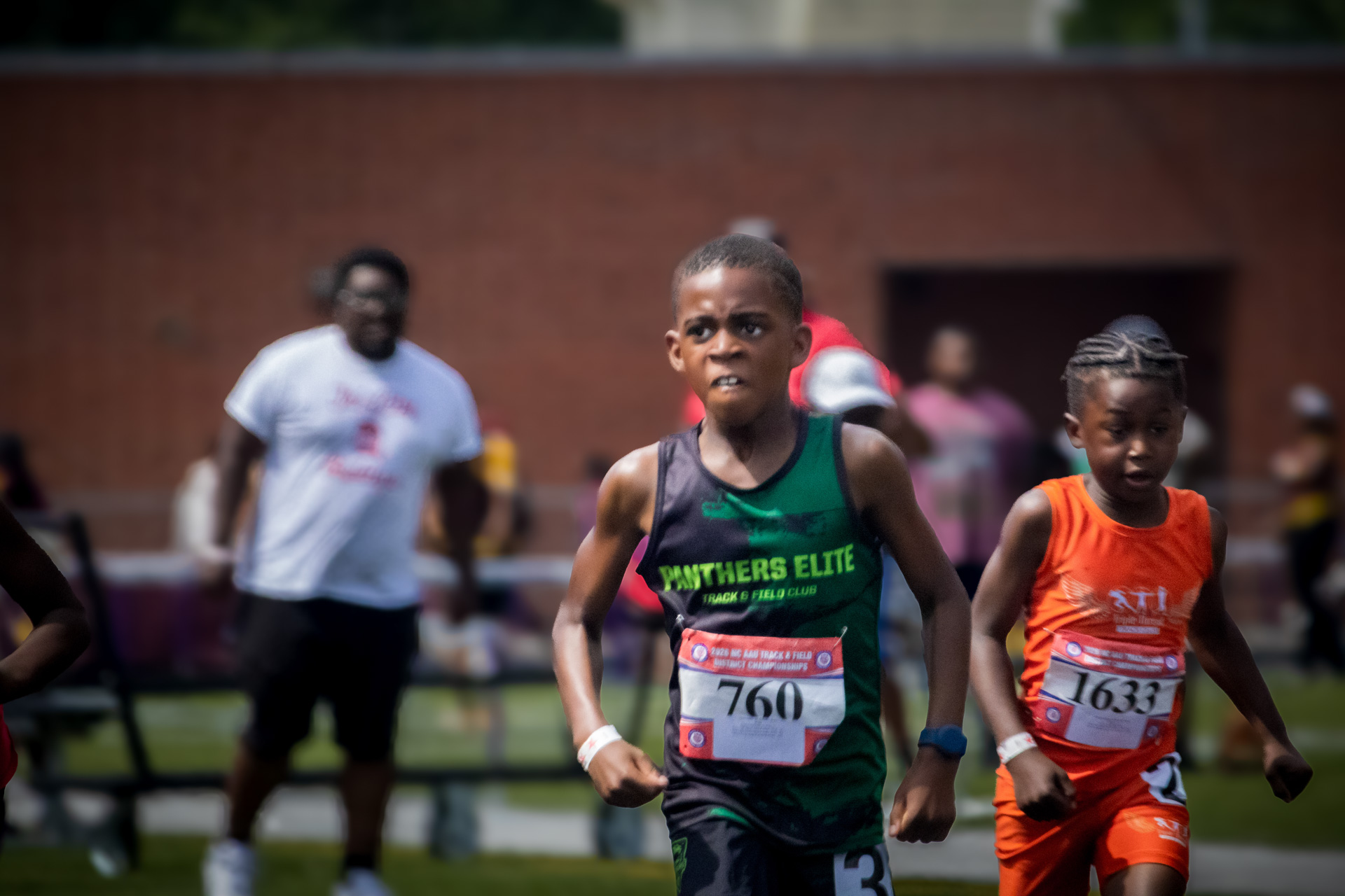 Young athletes competing in a track race at District Qualifier 2026.
