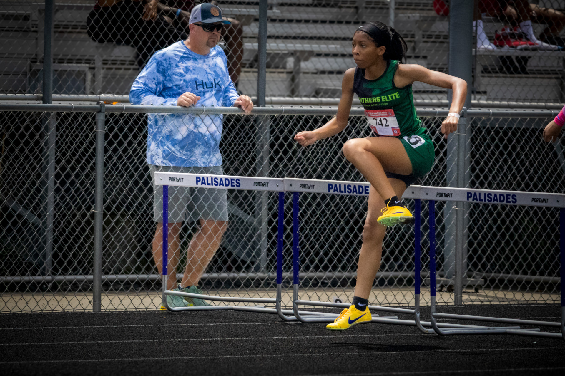 Female hurdler clearing hurdles at District Qualifier 2026.