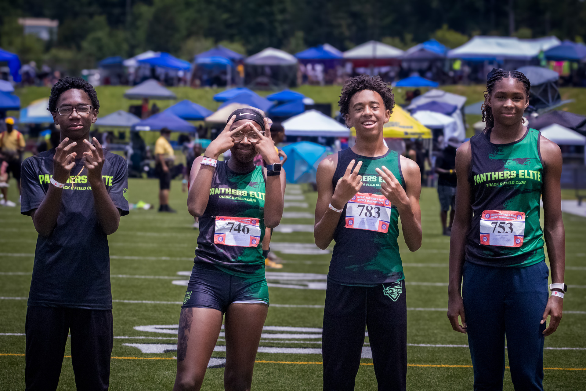 Group of young athletes from Panthers Elite Track & Field Club at district qualifier.