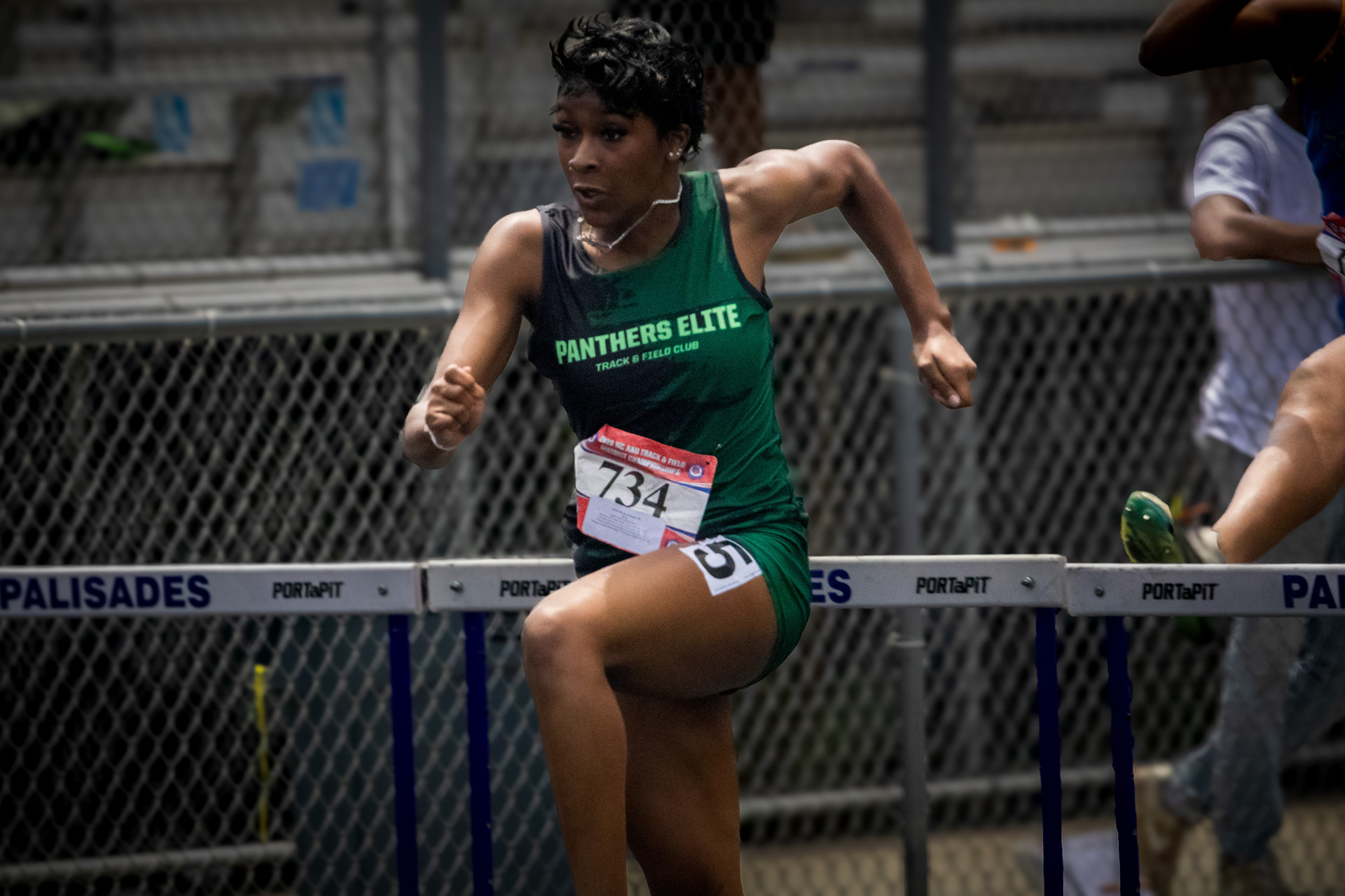 Female track athlete from Panthers Elite Club competing in hurdles.