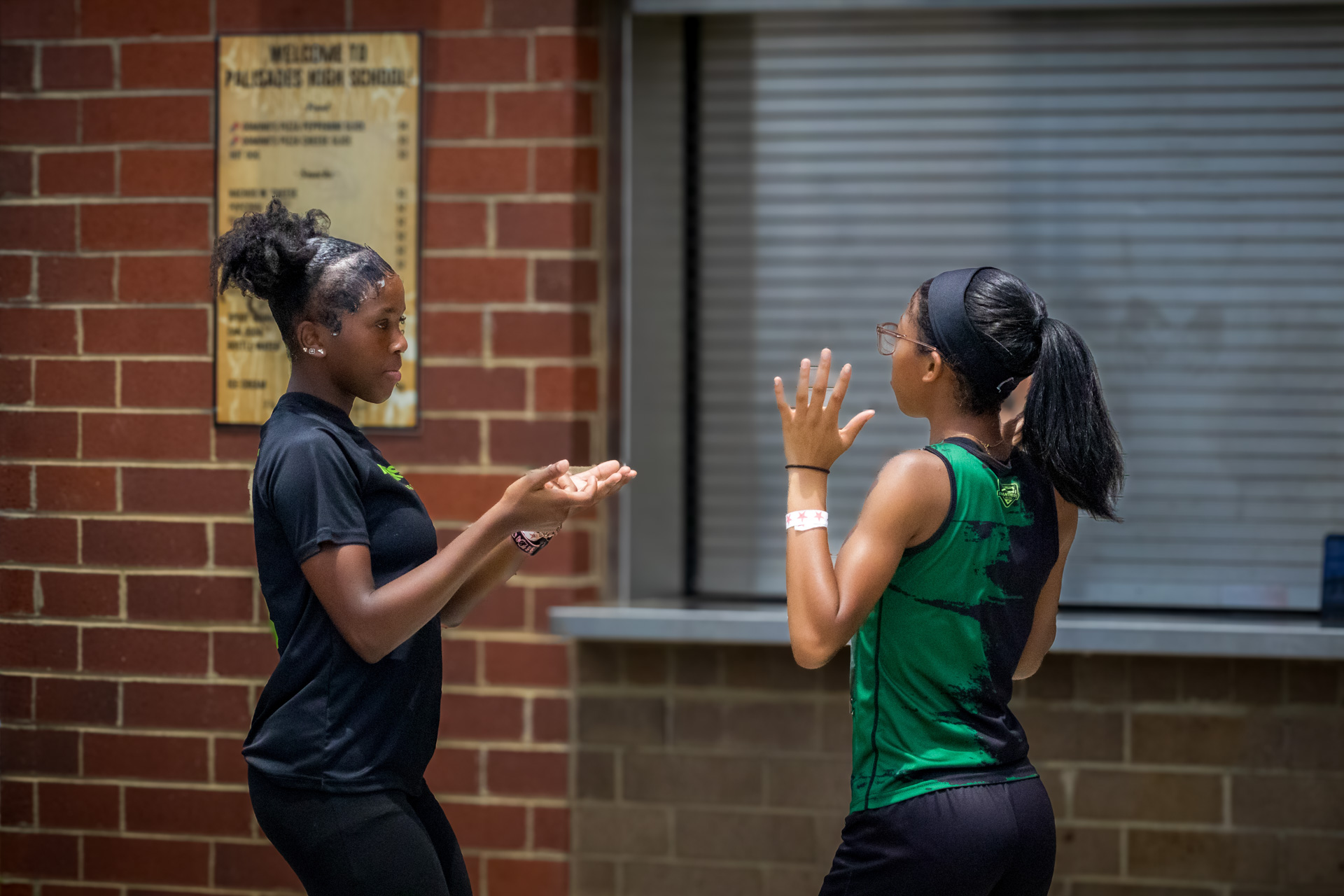 Two female athletes having a conversation at the District Qualifier 2026.