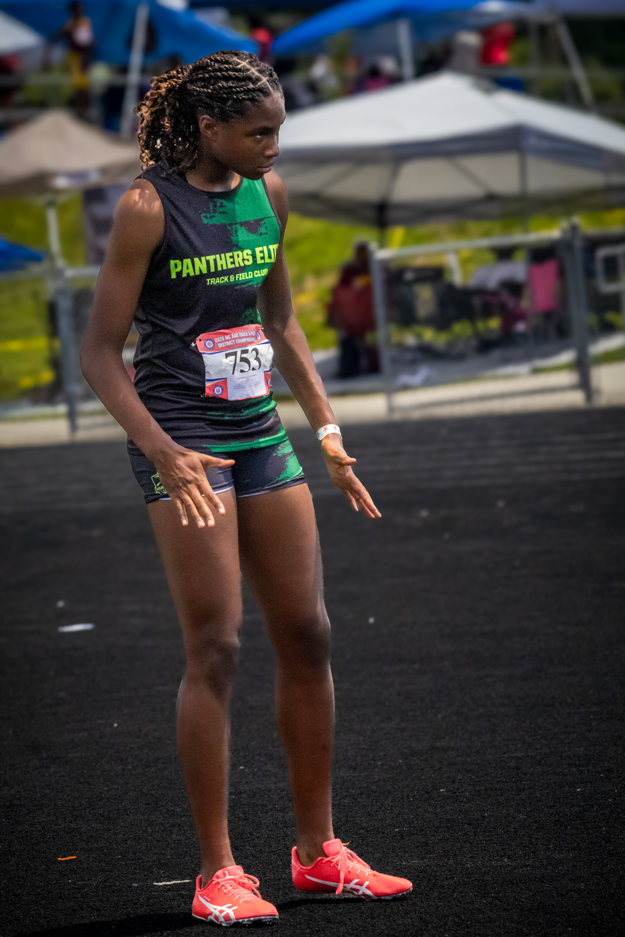 Young female athlete in Panthers Elite uniform at district qualifier.