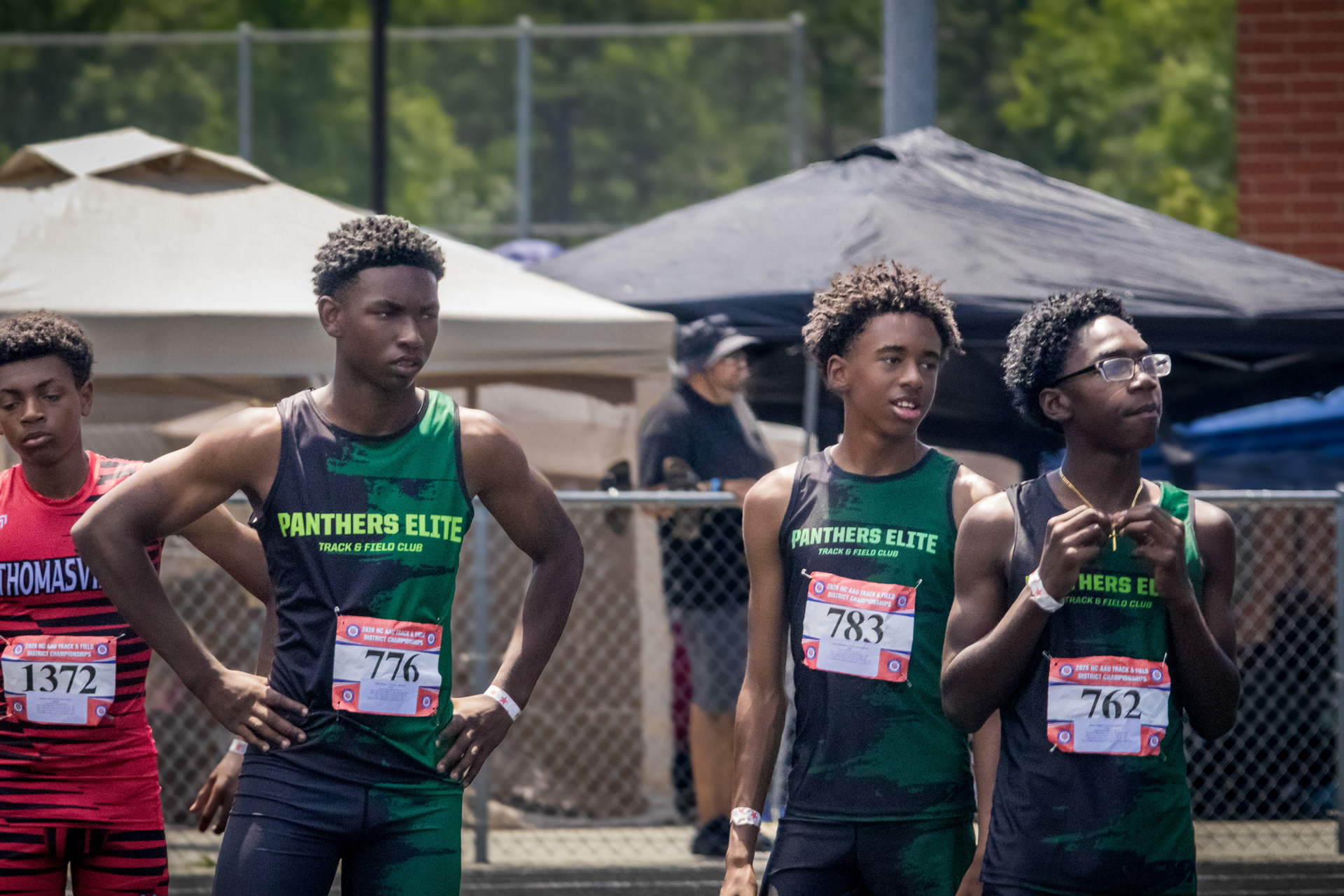 Panthers Elite runners at district track meet, ready for race.