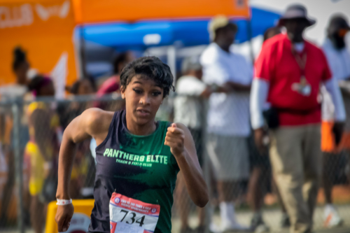 Female athlete from Panthers Elite Track & Field Club competing in race.