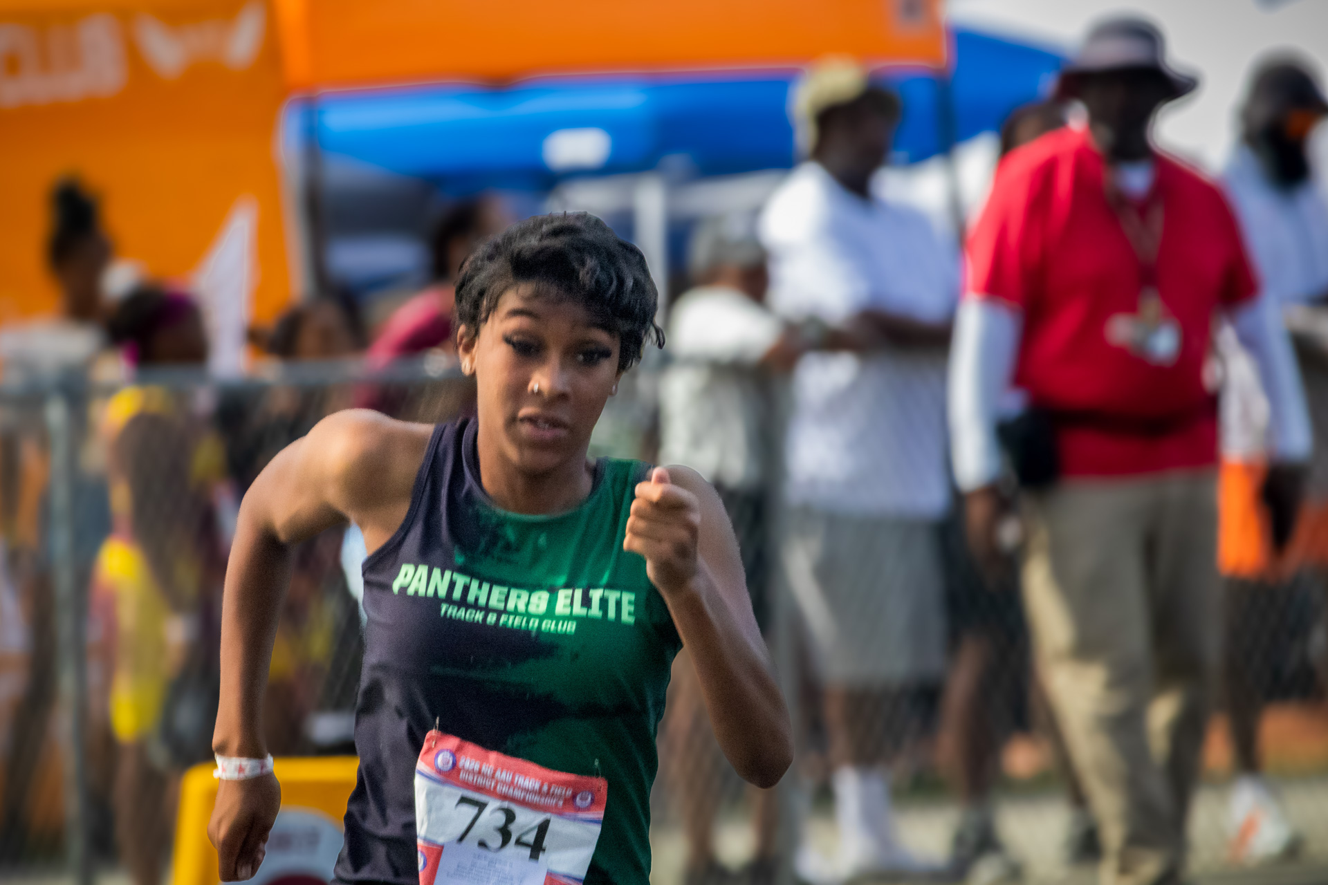 Female athlete from Panthers Elite Track & Field Club competing in race.
