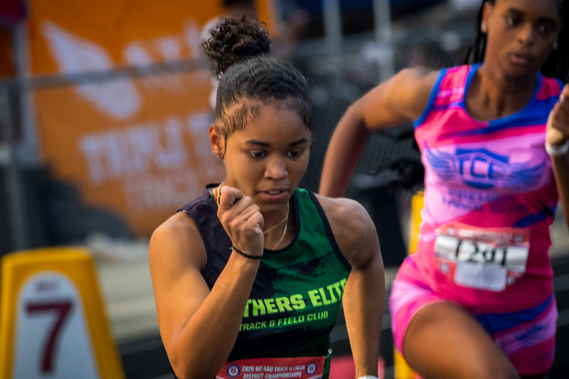 Young female runner in Panthers Elite uniform during a race.