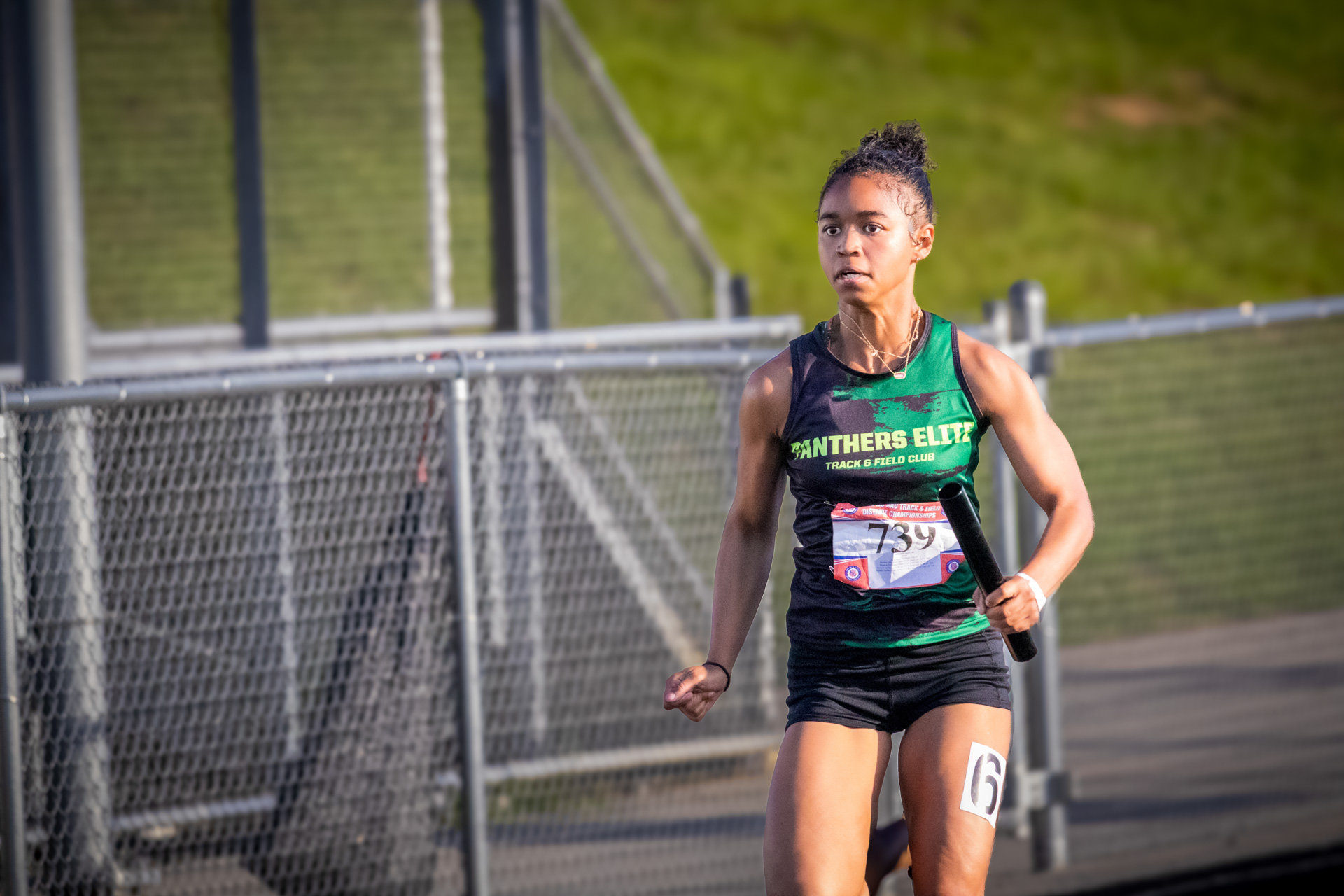 Female track athlete from Panthers Elite Track & Field Club during race.