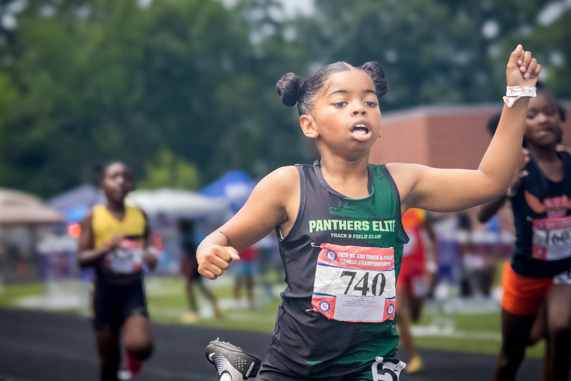 Young female runner from Panthers Elite Track & Field Club at district meet.