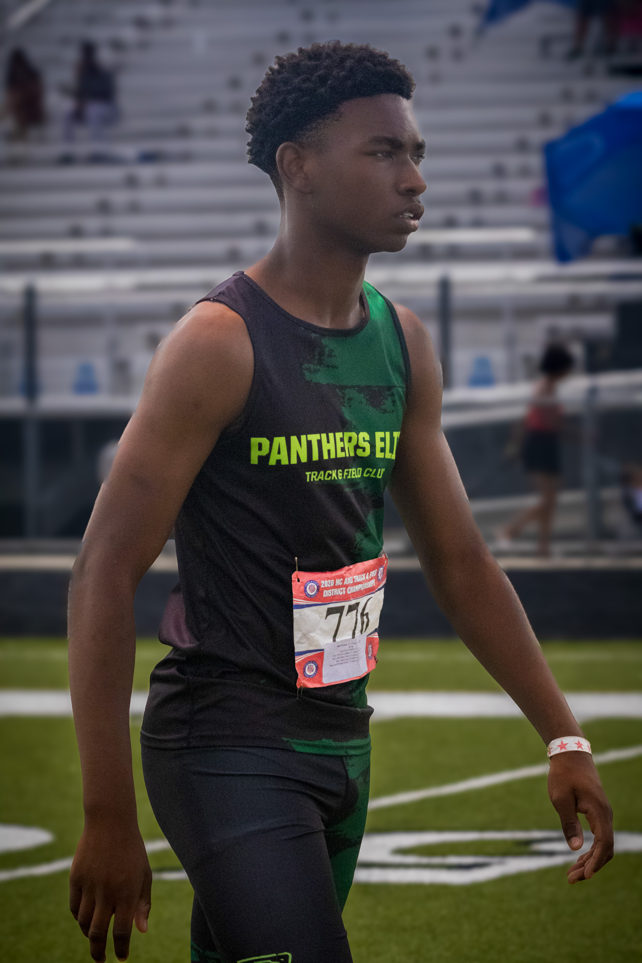 Young male athlete in Panthers Elite uniform at district qualifier.