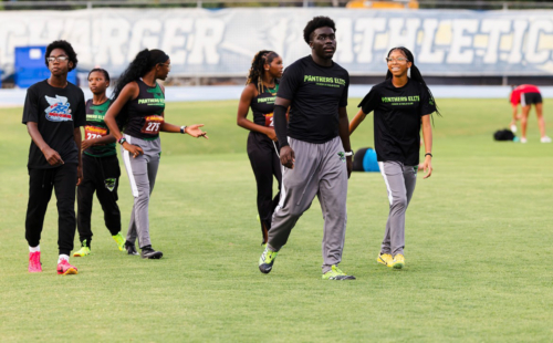 Panthers Elite athletes warming up on the track during The Victory Lap 2026 event.