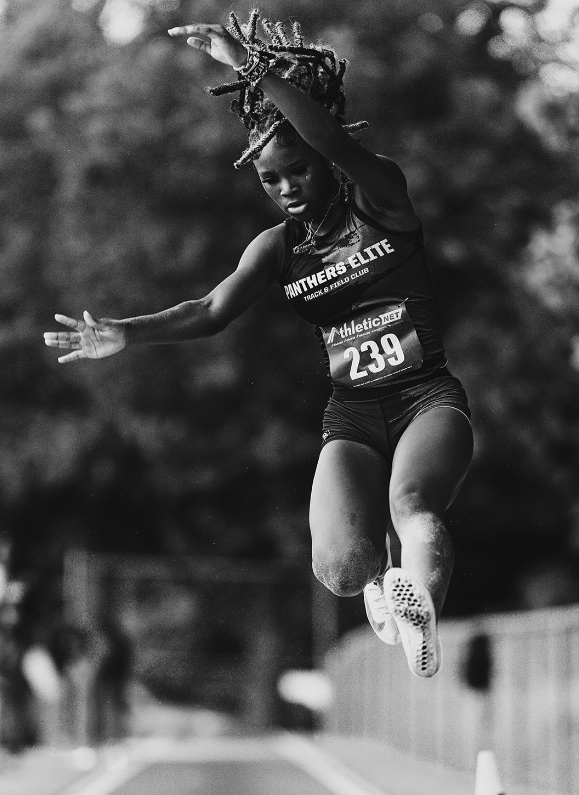 Young female athlete jumping during a track and field event at The Victory Lap 2026.