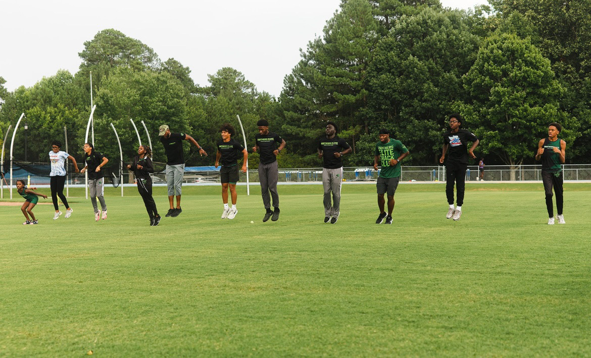 Panthers Elite athletes practicing on the track during a meet.