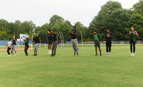 Panthers Elite athletes practicing on the track field during training session.